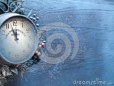 Christmas clock over snow wooden background. Stock Photo