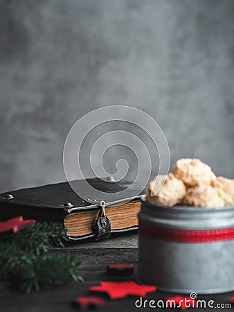 Christmas coconut meringue cookies in metal box and old bible on background. Stock Photo