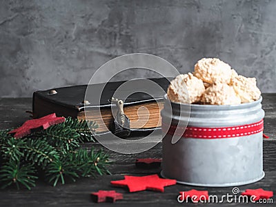 Christmas coconut meringue cookies in metal box and old bible on background Stock Photo