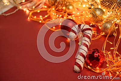 Christmas composition balls on a spruce branch on a red background . on the background of a Christmas garland . template for Stock Photo