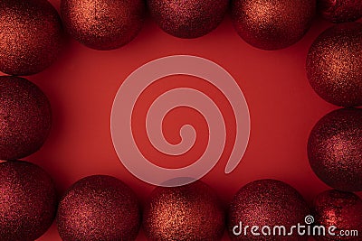 Christmas composition with copy space. New year balls or bubles red decorations on paper red background. Stock Photo