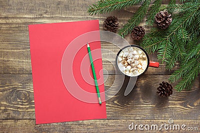 Christmas composition. Empty red blank for wishing to Santa and cup of coffee on the wooden. Top view with copy space. Stock Photo