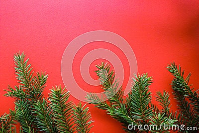 Christmas composition with gift boxes, clews of rope, paper`s rools and decorations, fir tree branches on red background. Stock Photo