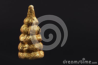 Christmas composition.Gold toy Christmas tree on a black background Stock Photo