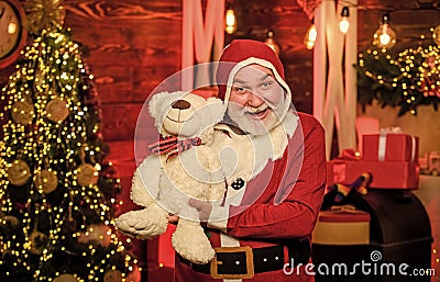 Christmas composition. holiday shopping online. cheerful santa man hold toys. teddy bear. bearded man love bear toy Stock Photo