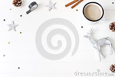 Christmas composition. Hot chocolate, pine cones, cinnamon sticks, stars confetti and reindeer on white table background Stock Photo