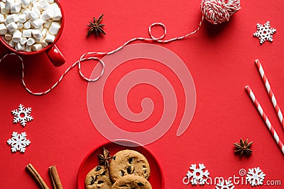 Christmas composition. Oatmeal cookies, hot chocolate with marshmallows, festive decorations on red background. Flat lay, top view Stock Photo