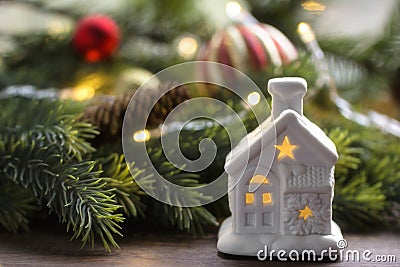 Christmas composition of red and gold Christmas balls, small fantastic lamp, spruce branches on a wooden brown surface. Stock Photo