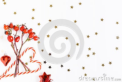 Christmas composition. Red rosehip berries on a white background and golden stars. Christmas, new year, winter concept Stock Photo