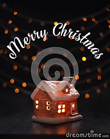 Christmas composition. Toy house on a black background blurry lights. Christmas, winter, new year concept Stock Photo