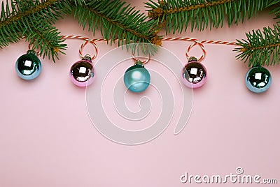 Christmas composition, trendy colors. Banner of shiny christmass garland with pink and skyblue balls over pink background Stock Photo