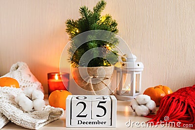 Christmas composition with wood calendar in Scandinavian hygge style. Beautiful cozy home decor composition with candles, lantern Stock Photo
