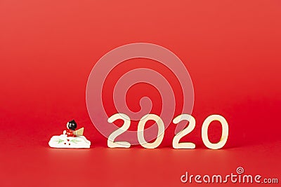 Christmas composition with wooden figures 2020 on a red background. Minimalization, space for text Stock Photo