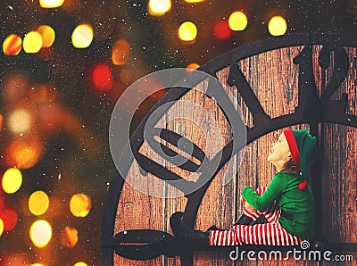 Christmas concept. Little Elf on clockwise Stock Photo