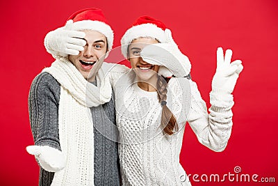 Christmas Concept - Young happy stylish couple in winter clothes close eyes each others celebrating in Christmas day Stock Photo