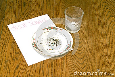 Christmas Cookie Crumbs and Empty Milk Glass on Table Stock Photo