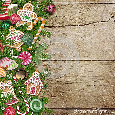 Christmas cookies, candy, pine branches on a wooden background Stock Photo