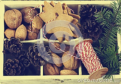 Christmas cookies, walnuts, nuts and pine cones in wooden box. Stock Photo