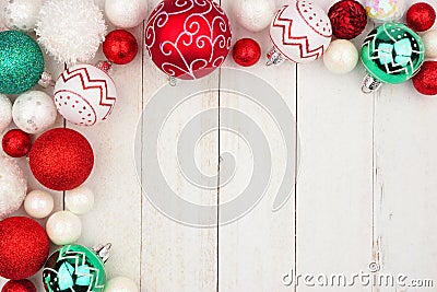 Christmas corner border of red, green and white ornaments on white wood Stock Photo