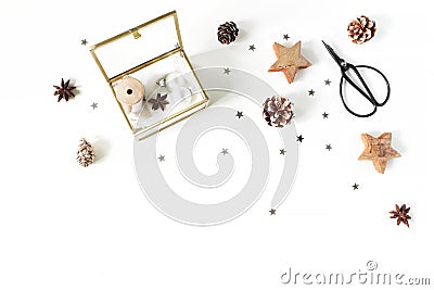 Christmas craft composition. Silk ribbons and Christmas balls in golden glass box. Vintage scissors, pine cones, silver Stock Photo