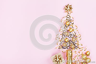 Christmas creative fir tree from champagne, confetti stars and serpentine with gift box on pink background top view. Flat lay. Stock Photo