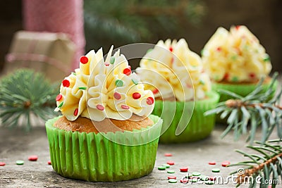 Christmas cupcakes with buttercream frosting and sugar confetti Stock Photo