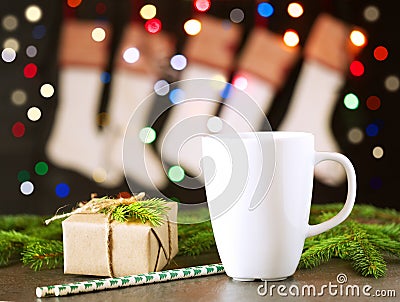 Christmas dark background, Christmas socks, gift, fir branches, cup with tea or coffee, magic bokeh, empty space Stock Photo