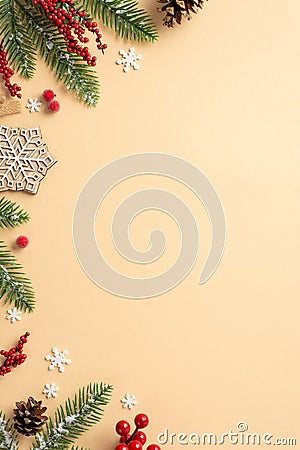 Christmas Day concept. Top view vertical photo of wooden snowflake ornament fir branches in frost pine cones and mistletoe berries Stock Photo