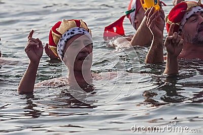 CHRISTMAS DAY HARBOUR SWIM 2015, BARCELONA, Port Vell - 25th December:Swimmers in carnival costumes greet the audience Editorial Stock Photo