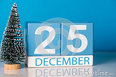 Christmas. December 25th. Day 25 of december month, calendar with little christmas tree on blue background. Winter time Stock Photo