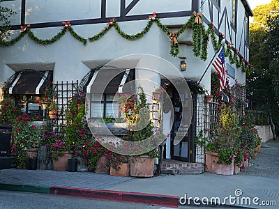 Christmas decorated boutique entrance with holiday lights, American flag Stock Photo