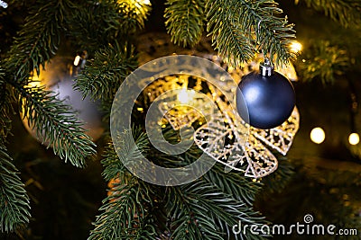 Christmas decoration balls branch. Christmas tree toy on spruce branches. Blue, gray, shiny toy ball and pine cone on the Stock Photo
