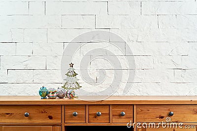 Christmas decoration with beautiful colorful baubles on the shelf on the background of a brick wall Stock Photo