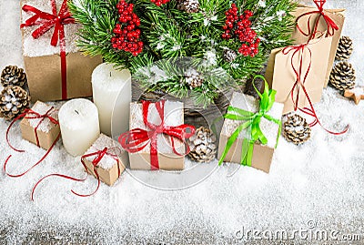 Christmas decoration with candles, gift boxes and snow Stock Photo