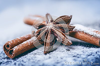 Christmas decoration and cookies.Woman hand sprinkling sugar on a cookies. Flour and spices for a baking on a dark backg Stock Photo