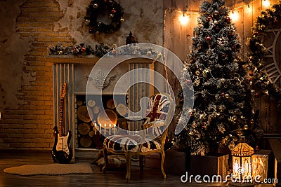 Christmas decoration in cozy house loft, fireplace Christmas tree guitar chair decoration toy boxes rug, candles, lantern candle Stock Photo