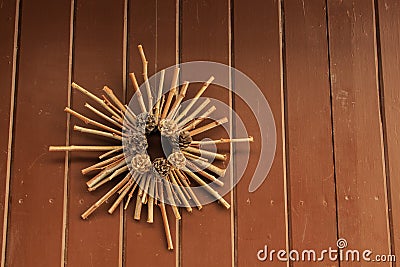 Christmas decoration hanging on exterior door with pine cones and wooden sticks. Christmas concept Stock Photo