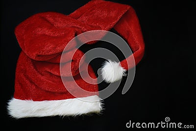 Christmas decoration with place for greeting on chalk blackboard. Santa Claus hat and gift boxes Stock Photo