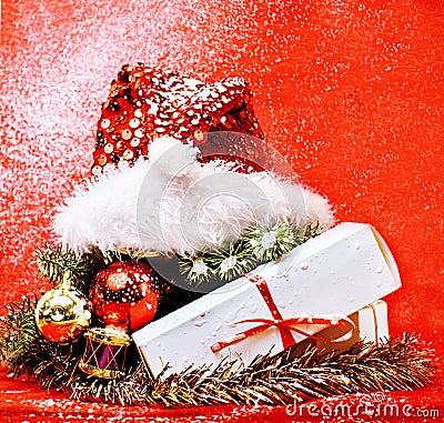 Christmas decoration , red background with snow for post card greetings, toy design on tree macro xmas gifts under Stock Photo