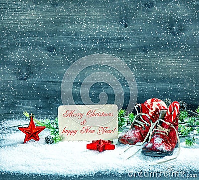 Christmas decoration red stars and antique baby shoes in snow Stock Photo