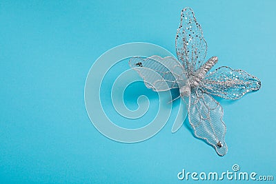 Christmas decoration silver butterfly on a blue background Stock Photo