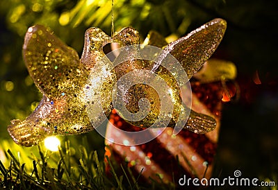 Christmas decoration of two turtle doves kissing in a tree in front of a wrapped present. Stock Photo