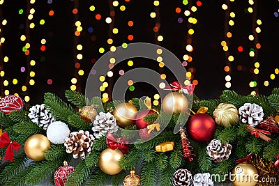 Christmas decoration on white fur with fir tree branch closeup, gifts, xmas ball, cone and other object on dark background, lights Stock Photo
