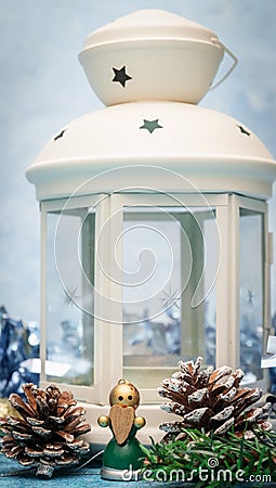 Christmas decorations. Candlestick candle close-up with a small wooden angel with a heart in his hands Stock Photo