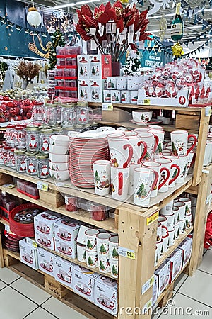 Christmas decorations, ceramic cups, glasses and balls, sells on a shop counter. Festive shopping in mall Editorial Stock Photo