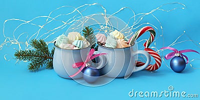 Christmas decorations, a couple of cups of coffee with meringues on a blue background Stock Photo