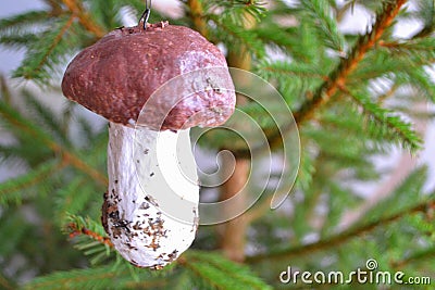 Christmas decorations. Handmade cep mushroom hanging on a branch of spruce Stock Photo