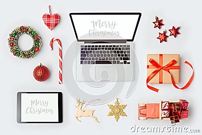 Christmas decorations, laptop computer and objects for mock up template design.View from above. Stock Photo