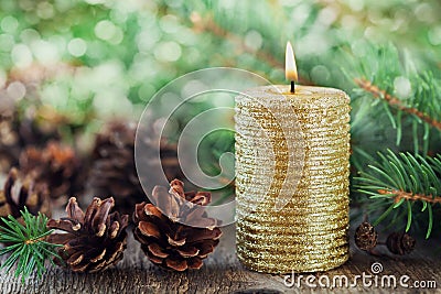 Christmas decorations with lighted candle, pine cones and fir branches on wooden background with magic bokeh effect, Christmas car Stock Photo