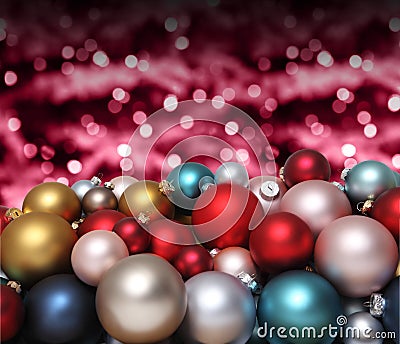 Christmas decorations, pile of glass colored balls isolated on blurred red bright lights, useful as a greeting gift card Stock Photo